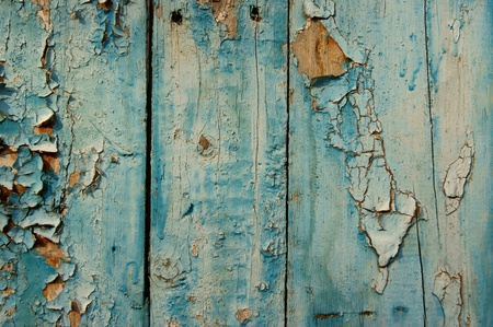 Old fence with the remains of old blue paint  
