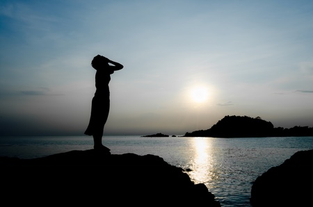 woman cry stand inside the sea sunset aloneの写真素材