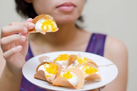 kind of Thai sweetmeat filled pancake in thai call kaÌ€-noÌ†m beÌ‚uang yuan