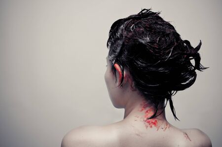 studio shot of woman with bloody hairの写真素材
