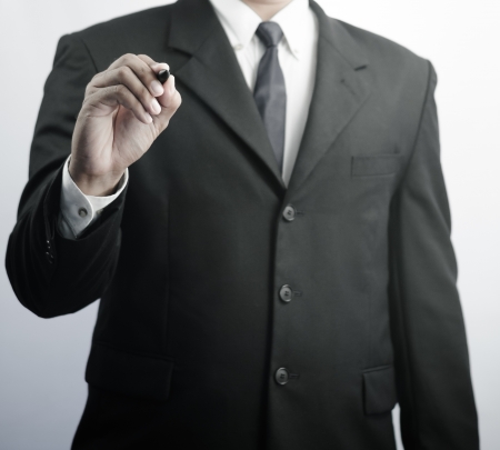 Business man writing with marker isolated on white backgroundの写真素材