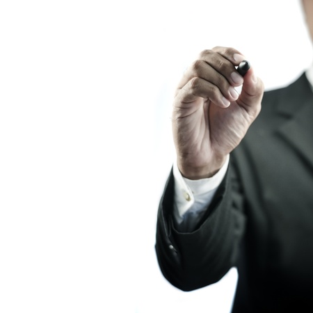 Business man writing with marker isolated on white backgroundの写真素材