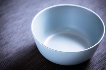 Blue empty bowl on black backgroundの写真素材