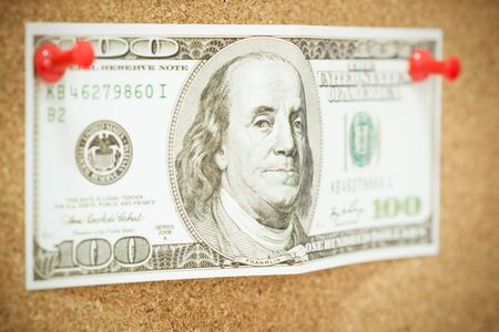 A one hundred dollar bill tacked to a corkboard, Getting Cash