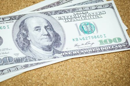 dollar bills on a wooden tableの写真素材