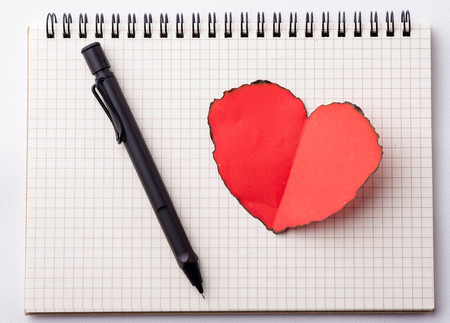 Love heart on notebook with penの写真素材