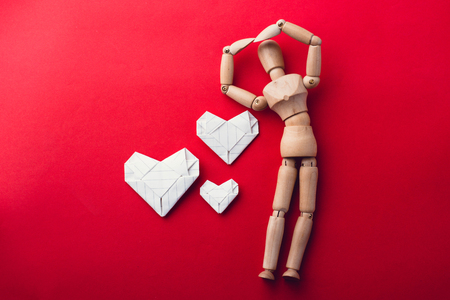 wooden dummy and paper harte on red background,love conceptの写真素材