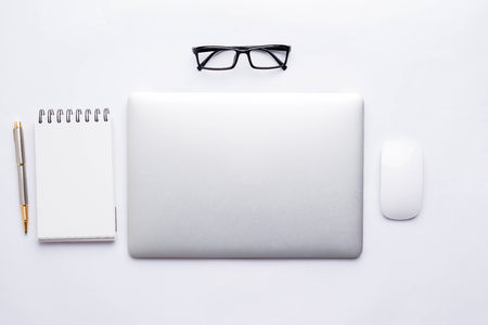 top view of White office desk table with a lot of things on it.の写真素材