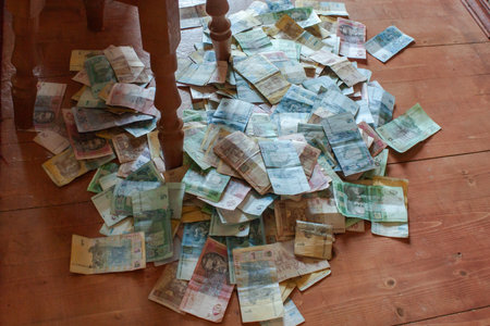 Pile of banknotes on the wooden floor. Money background.
