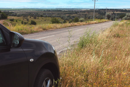 majestic panoramic view from the hill to the open spaces, road and carの写真素材