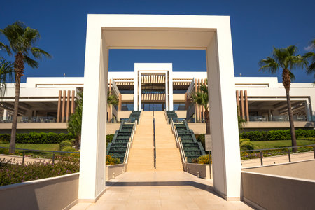 Rectangular white arches with steps create a symmetrical geometric picture on the hotel groundsの写真素材