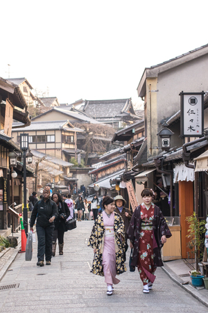 Kyoto, Japan - February 25, 2014 - Fake geishas in Sannen Zaka street at sunset in Kyoto, Japanのeditorial素材