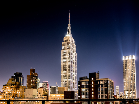 NEW YORK, USA - JANUARY 5, 2015: The Empire State Building seen through the Manhattan Bridge in the afternoon. The Empire State Building is a 102-story landmark in New York.のeditorial素材