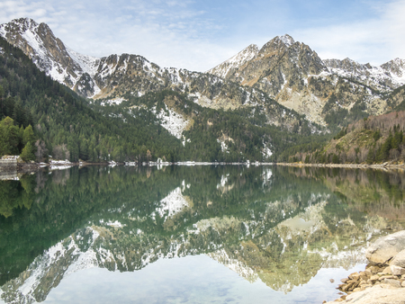 The reflections of the mountains on the waters of the lakeの写真素材