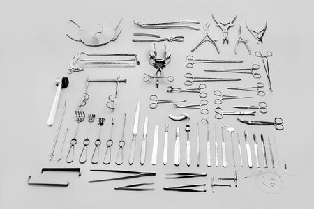 Medical instruments used for surgical operations, laid out on a gray backgroundの写真素材