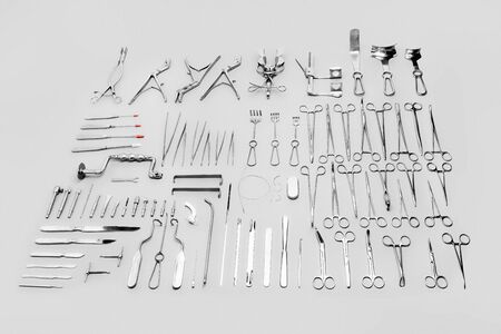 Medical instruments used for surgical operations, laid out on a gray backgroundの写真素材