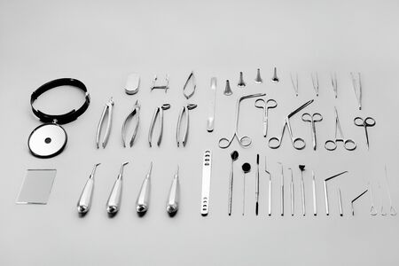 Medical instruments used for surgical operations, laid out on a gray backgroundの写真素材