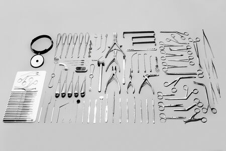 Medical instruments used for surgical operations, laid out on a gray backgroundの写真素材