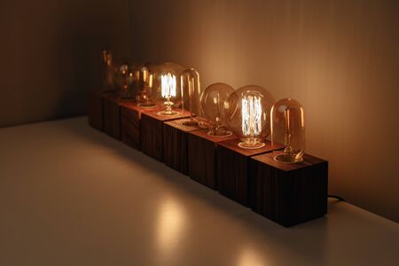 Row of old-fashioned steampunk style lamps on variety of wooden basesの写真素材