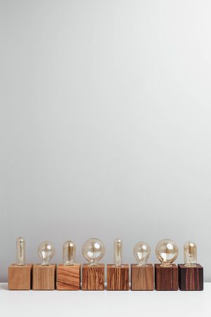 Row of old-fashioned steampunk style lamps on variety of wooden basesの写真素材