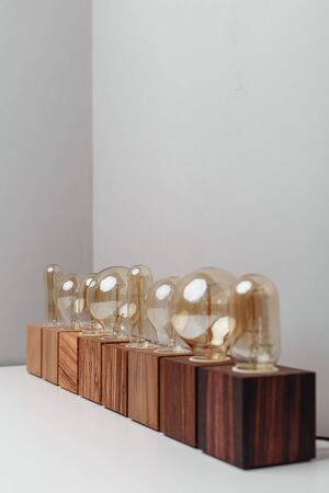 Row of old-fashioned steampunk style lamps on variety of wooden basesの写真素材