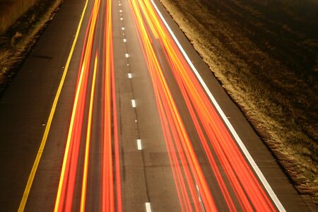 Orange stripes created by tail lights on the highway