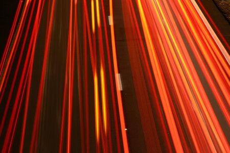 Orange stripes created by tail lights on the highwayの写真素材
