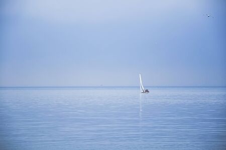 Seascape with sailboat the background of the blue sky.の写真素材