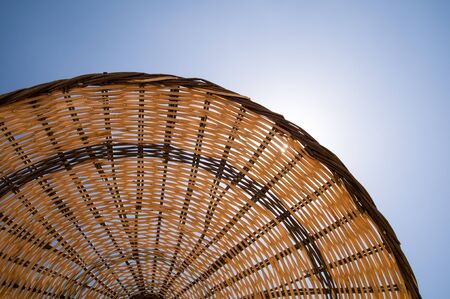 Straw umbrella on a beach.