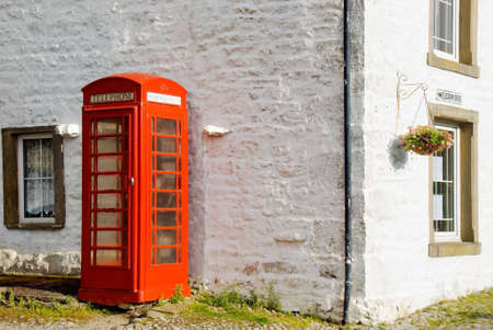 Phonebox standing against telegraph office in Yorkshire Dalesの写真素材