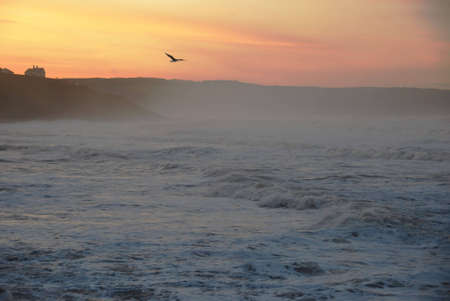 Stormy seas at sunset off Whitby, North Yorkshire, England, UKの写真素材