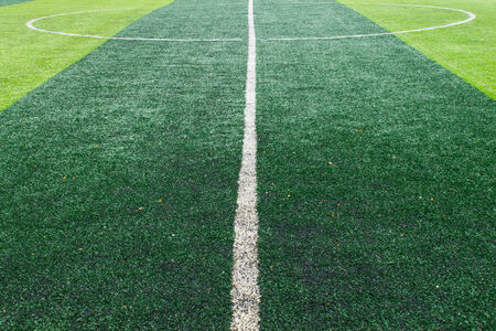 White center line of soccer field. Center line on artificial grass football fieldの写真素材