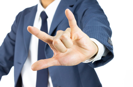 Businessman in Blue Suit Show I Love You Sign or Thumb and Finger and Little Finger Isolated on White Background. Concept about Love or Romanceの写真素材
