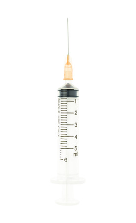 Plastic orange syringe isolated on white background on vertical view. Single use medical tool in hospital for injection.の写真素材