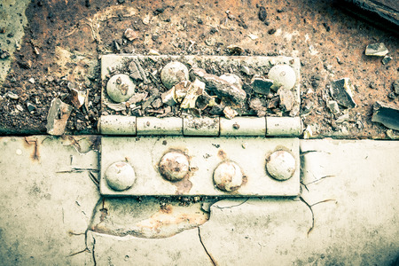 Old metal hinge and rust and rivet on old metal sheet of auto part in horizontal view high contrast style. Grunge or retro or old background for industry design.の写真素材