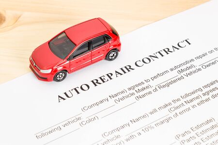 Auto repair contract with red car on left view. Car repair agreement or legal documentの写真素材