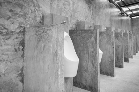 White urinal men with concrete wall loft style for interior design or exterior design. White urinal men in public toilet. Chamber pot or urinal 
 men classic and retro style Wide Angle Black and Whiteの写真素材