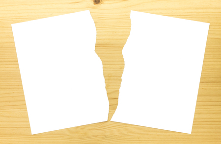 White Ripped Paper in Half on Wood Background. White torn paper 2 part for separate or partition or divide conceptの写真素材