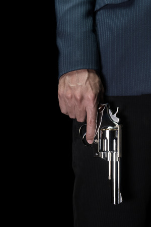 Man Hold Stainless Gun or Shooter in Hand Book Cover Style. Fake Stainless Gun or Shooter in Hand portrait view for criminal or violence conceptの写真素材