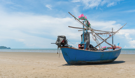 Blue fishing boat or fisherman boat or ship on Sam Roi Yod bech Prachuap Khiri Khan Thailand with blue sky and cloud and blue sea. Landscape or scenery for summer season conceptの写真素材