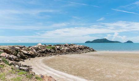 Rock or stone mound or pile on the beach at Prachuap Khiri Khan Thailand. Beach and sea or brine and blue sky and green tree mountain or hill. 
Summer concept in relaxation mood for designの写真素材