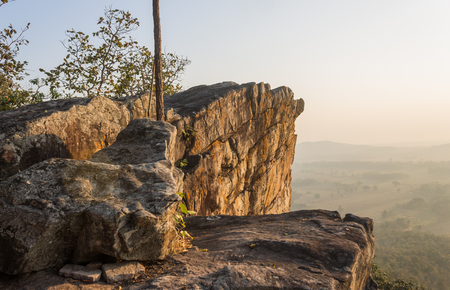 Pha Hua Rue Rock Cliff Mountain Hill Phayao Attractions Thailand with Warm Sun Light and Green Tree Landscape Left Wide. Natural stone or rock mountain hill at Phayao northern Thailand travelの写真素材