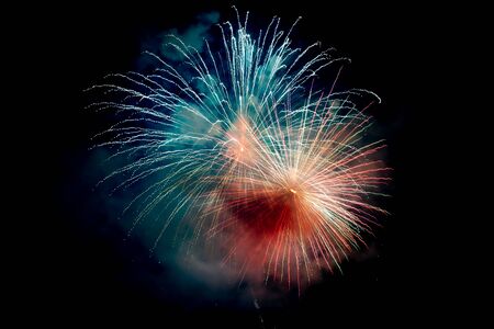 Blue Orange Sparkling Fireworks Background on Night Scene. Abstract color fireworks background and...