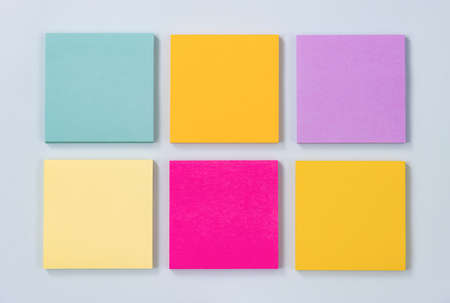 6 Color Sticky Note or Note Pad as Green,Purple,Pink,Yellow on Modern Clean Creative Office Desk or Office Table on Top View. Office Supplies on Blue Pastel Minimalist Backgroundの写真素材