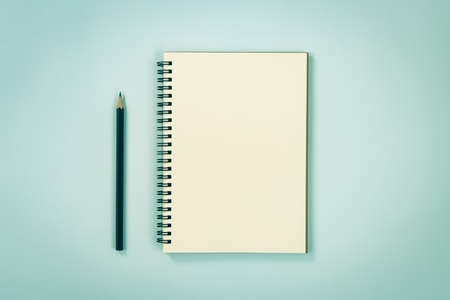 Spiral Notebook or Spring Notebook in Unlined Type and Pencil on Blue Pastel Minimalist Background in Vintage Toneの写真素材