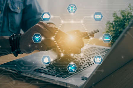 Casual Businessman Touching Smart Phone or Mobile Phone Screen by Finger on Laptop Computer and Blue Hexagon Social Communication Sign Search Icon,Position Pin,Wifi,Cloud in Vintage Toneの写真素材