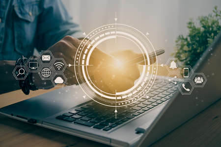 Casual Businessman Touching Smart Phone or Mobile Phone Screen by Finger on Laptop Computer and HUD Social Communication Sign Search Icon,Position Pin,Wifi,Cloud in Vintage Toneの写真素材
