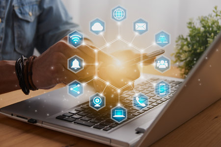 Casual Businessman Touching Smart Phone or Mobile Phone Screen by Finger on Laptop Computer and Blue Hexagonal Social Communication Sign Search Icon,Position Pin,Wifi,Cloudの写真素材