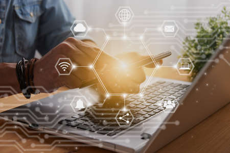 Casual Businessman Touching Smart Phone or Mobile Phone Screen by Finger on Laptop Computer and Hexagon Social Communication Sign Search Icon,Position Pin,Wifi,Cloudの写真素材
