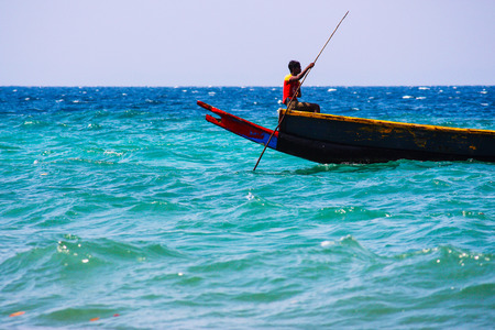 Havelock Island, Andaman and Nicobar Islands - January 2, 2010: Indian fisherman on his boat in the seaのeditorial素材